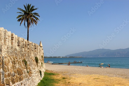 Beach at the fortress of Lepanto in Nafpaktos town in Greece in the summertime. Selective focus photo