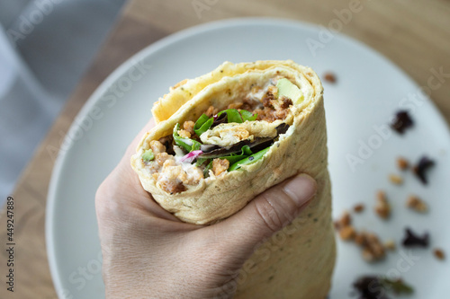 Vegan and gluten free homemade burrito. Burrito stuffed with soy, avocado, tomato, mayonnaise and lettuce © SylviePM