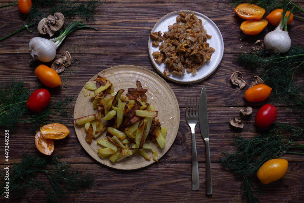 Russian cuisine fried potatoes with mushrooms on a wooden table Russian cuisine fried potatoes with mushrooms on a wooden table
