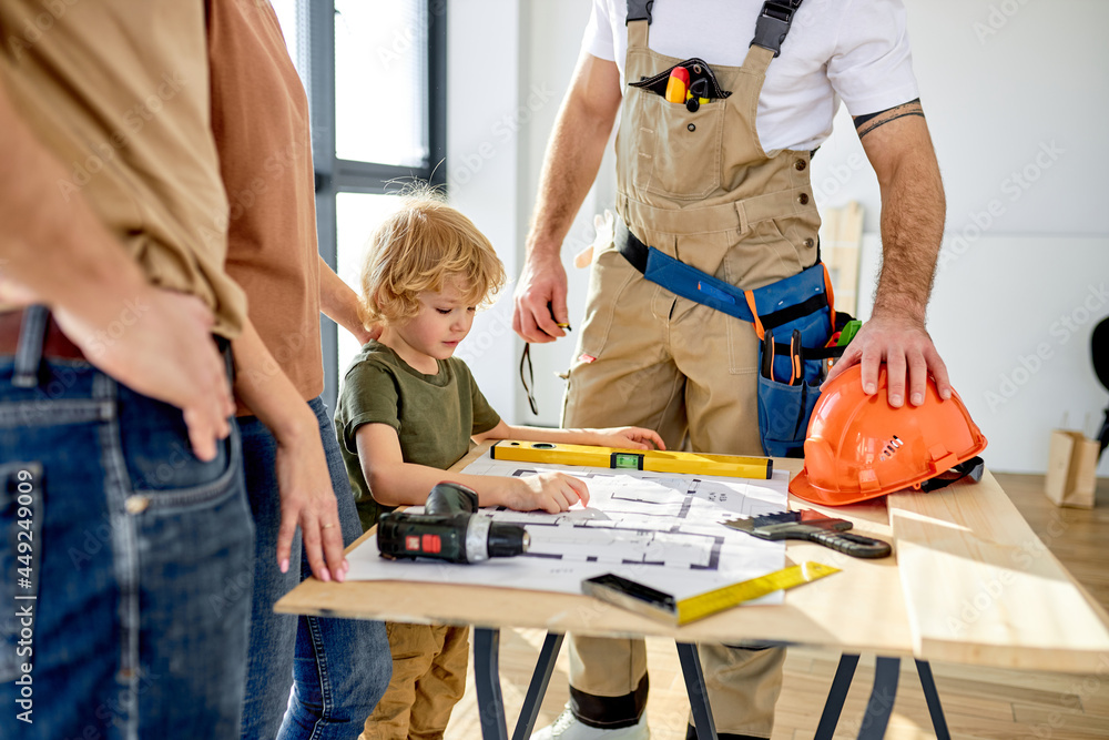 construction worker assistant with family in new house. Builder and ...