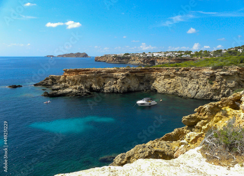 landscape ibiza with motorboat in the sea on a sunny day