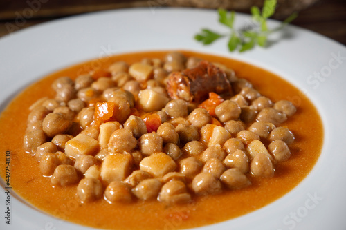 Chickpea stew dish, cocido madrileño. With beef, sausage (chorizo), bacon, carrots and bread.