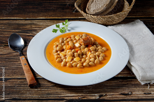Chickpea stew dish, cocido madrileño. With beef, sausage (chorizo), bacon, carrots and bread.