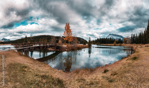 Cascade ponds with mount Rundle, wooden bridge and dramatic sky at Banff national park