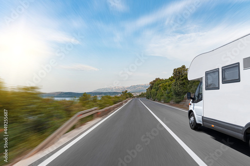 Motorhomes on the highway. A white car Motorhomes drives along a scenic road. © Denis Rozhnovsky