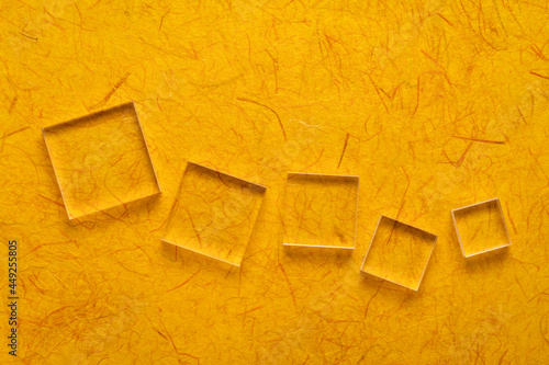 acrylic blocks against dark yellow gampi paper, handmade in Philippines photo