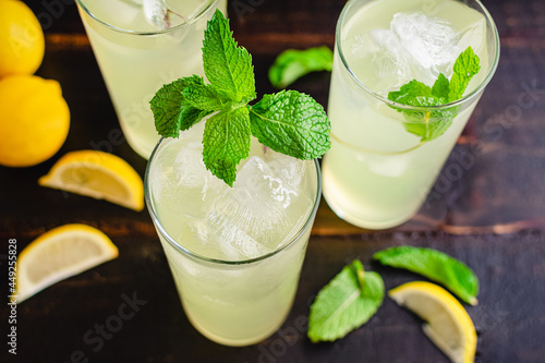 Glasses Limonata Turkish Lemonade with a Mint Garnish: Lemonade with a mint garnish on a wooden table photo