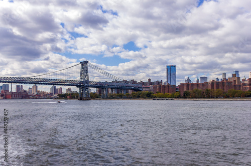 A picture of Williamsburg Bridge in New York City, USA. In the picture one can see the East River and Manhattan skyline