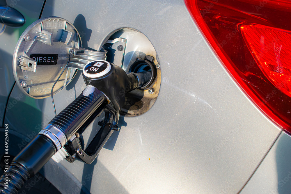 Fototapeta premium refueling the car, the gun in the fuel filler