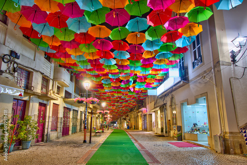 Colorful umbrellas in the street during the Agitágueda street festival in Águeda, Portugal