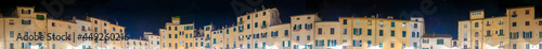 Piazza Anfiteatro at night in Lucca, Italy. Panoramic view.
