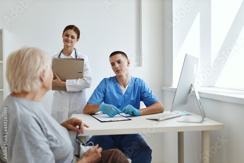 woman patient communicates with doctor and nurse in hospital help diagnostics