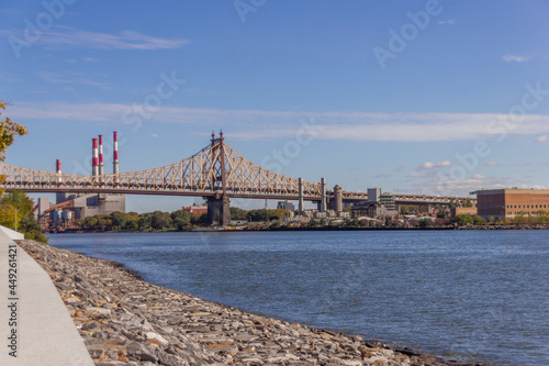 A picture of Ed Koch Queensboro Bridge in New York City  USA. In the picture one can see the East River  the Roosevelt island  Brooklyn and Domino Sugar Refinery and park