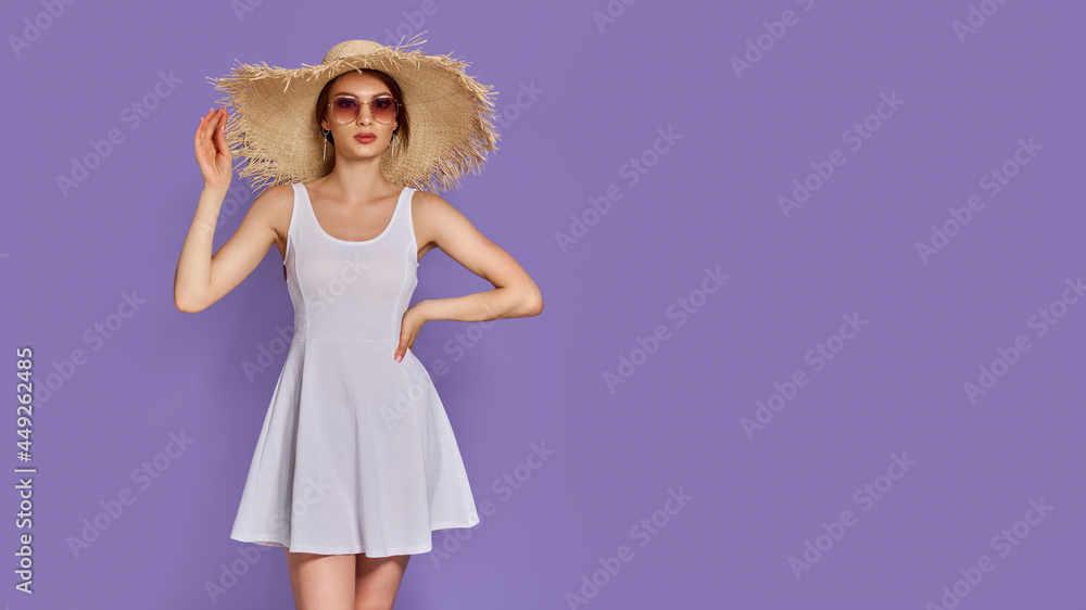 Photo of young fashion woman 20s wearing dress with straw hat and sunglasses isolated over violet background Photo of young fashion woman 20s wearing dress with straw hat and sunglasses isolated over violet background