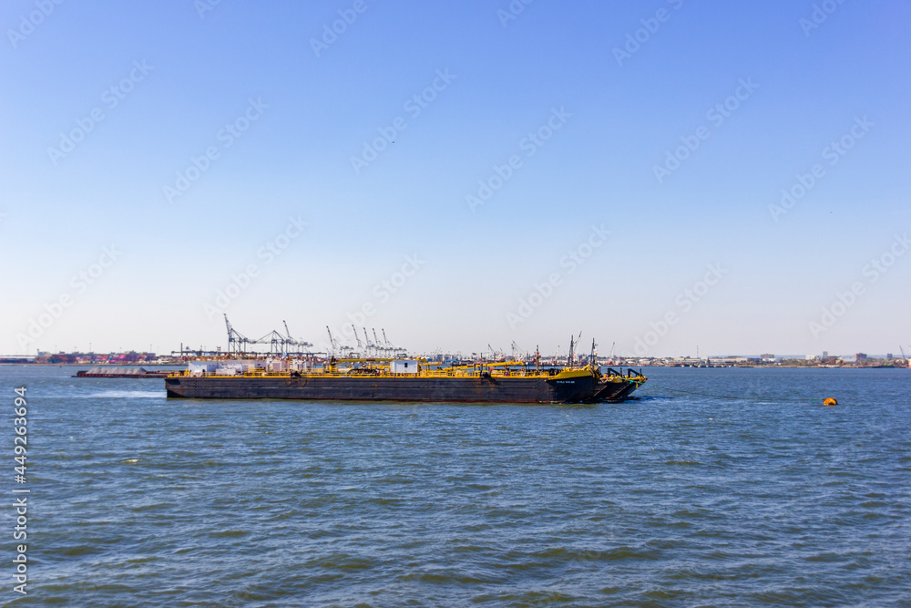 A boat shipping cargo between New York and New Jersey, USA