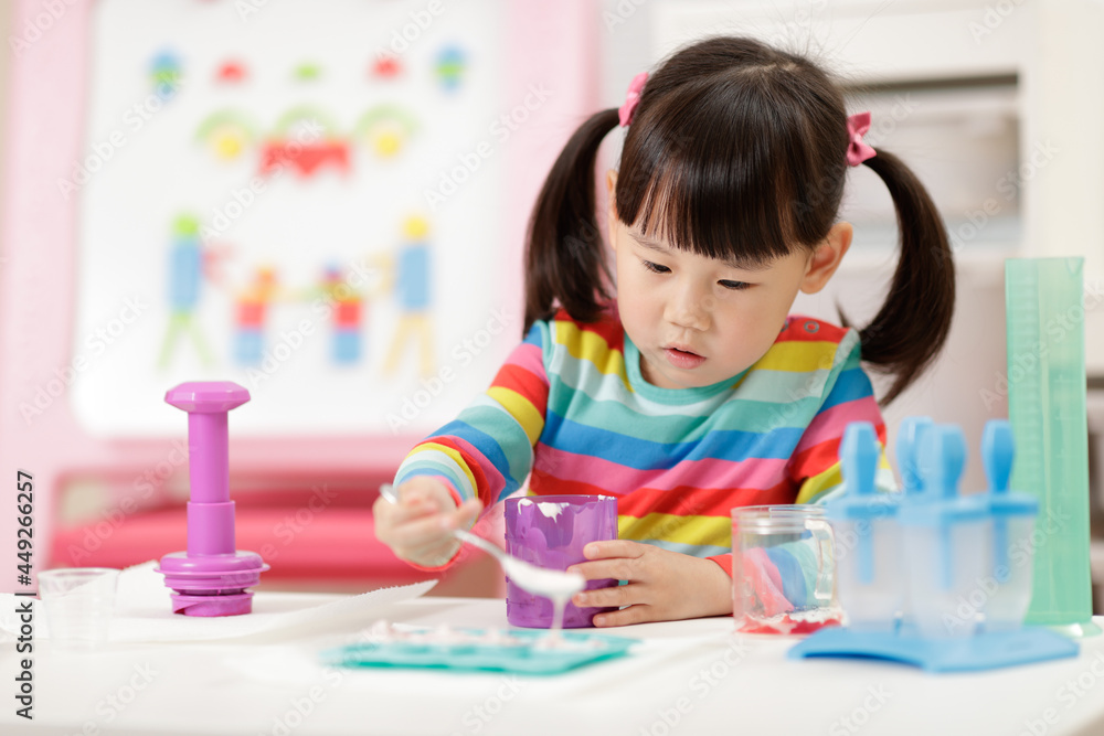 young girl pretend playing food preparing at home