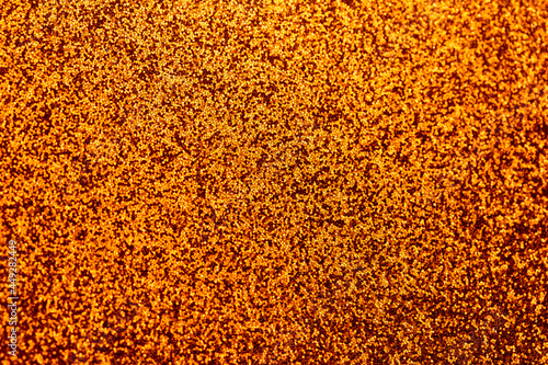 Autumn gold shiny glitter texture background with vibrant color