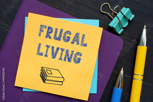  FRUGAL LIVING text in search line. Broker looking at smartphone.