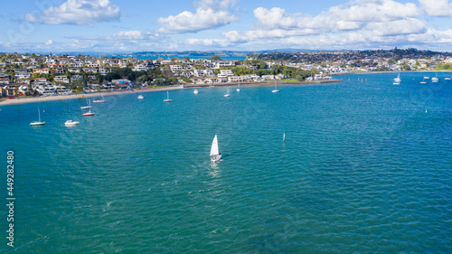Fototapeta Naklejka Na Ścianę i Meble -  Aerial View from the Beach, Green Trees, City Streets and Waves - Tahuna Torea, Bucklands Beach View in New Zealand - Auckland Area
