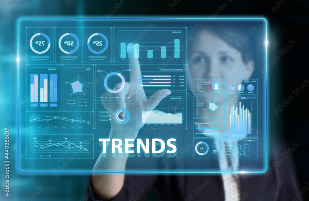 Obraz premium Business, Technology, Internet and network concept. Young businessman working on a virtual screen of the future and sees the inscription: Trends