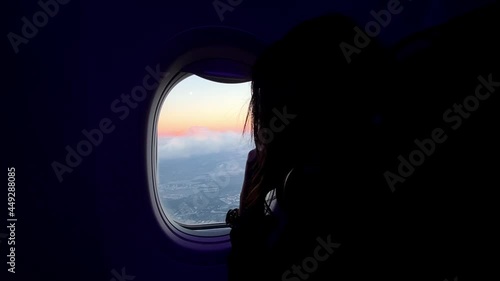 Wallpaper Mural Woman On The Seat Looking Out An Airplane Window With Colorful Sky. - Side View Shot Torontodigital.ca