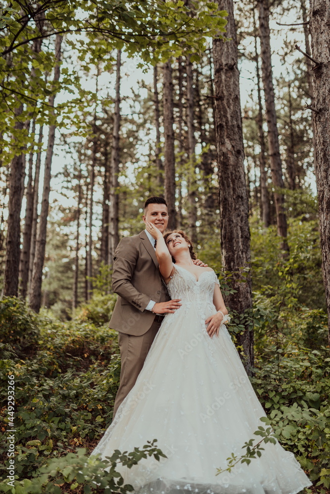 luxury stylish young bride and groom on the background spring sunny green forest. Couple in love. luxury stylish young bride and groom on the background spring sunny green forest. Couple in love.