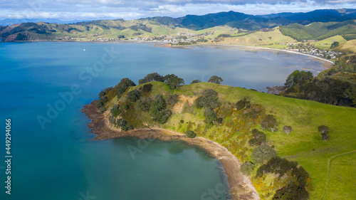 Aerial View of Waitawa Regional Park, Beach, Pier, Deck Green Trees and Cliff in New Zealand - Auckland Area