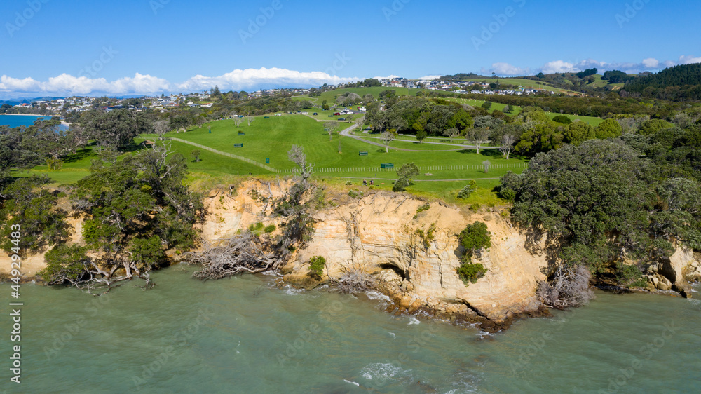 Aerial View of Grahams Beach close to the park, Green Trees and Cliff in New Zealand - Auckland Area