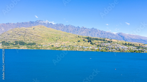 Aerial View from Houses close to the Beach, Lake Wakatipu, Green Trees, Mountains - Queenstown in New Zealand © Rodrigo