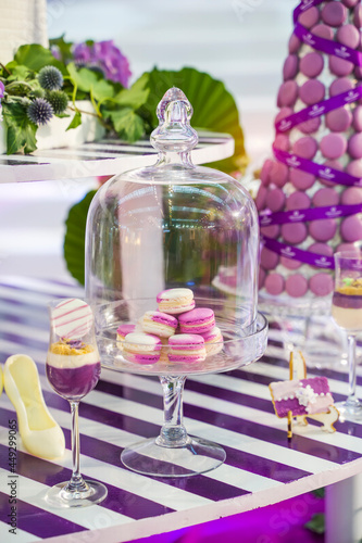 Wedding decoration with colorful macarons and cakes.