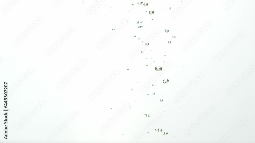 Bunch of red grapes dropped into water. Bubbles rise. Isolated white background Bunch of red grapes dropped into water. Bubbles rise. Isolated white background