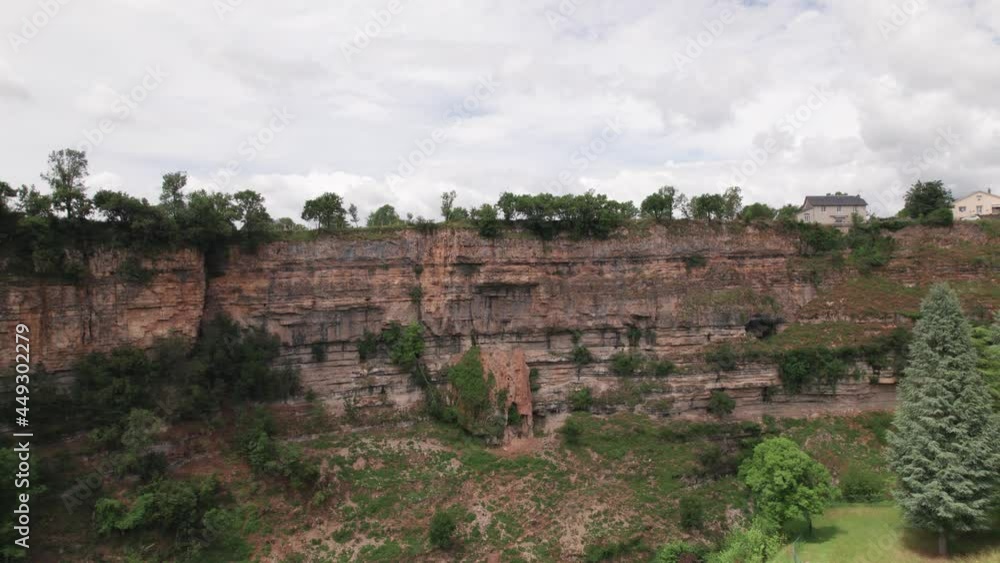 Scenic View Of Structures On Limestone Cliffs Against Cloudscape Sky. - Zoom In Scenic View Of Structures On Limestone Cliffs Against Cloudscape Sky. - Zoom In