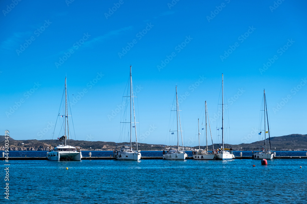 Milos island, Adamas port, Cyclades Greece. Moored white boats vessels yachts.