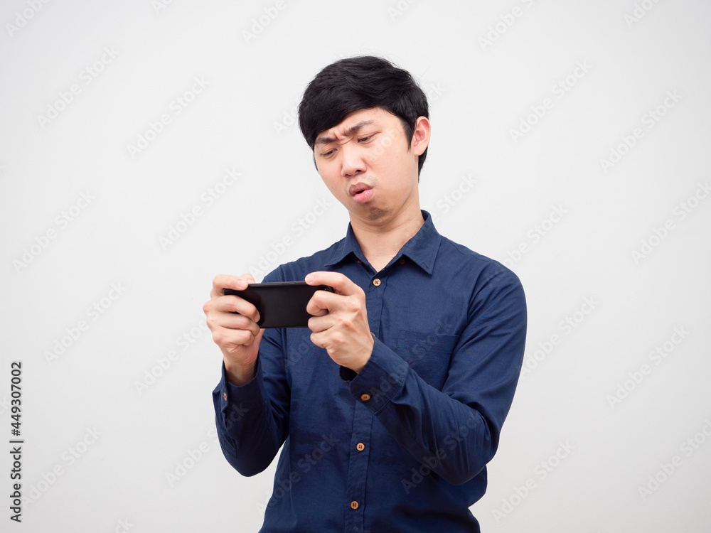 Asian man playing game mobile loss feeling bored portrait white background Asian man playing game mobile loss feeling bored portrait white background