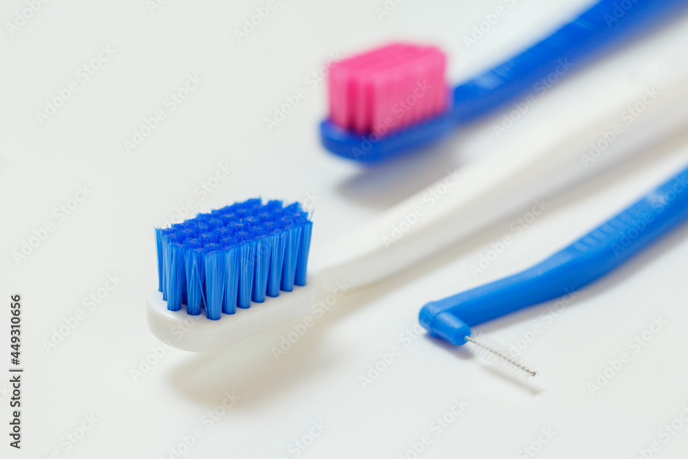 Toothbrushes and interdental brush on the white background. Toothbrushes and interdental brush on the white background.
