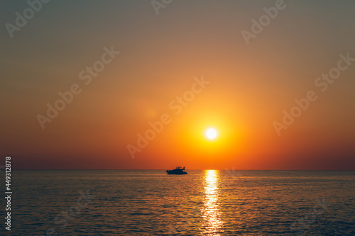 Silhouette of small yacht, ship floating on sea at sunset. Istria, Croatia © Space Creator