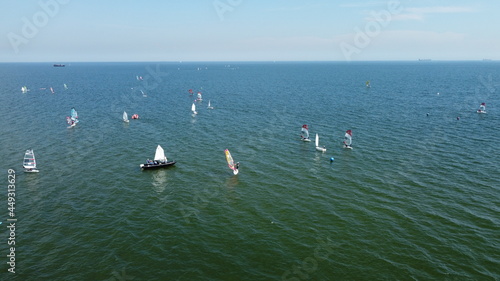 Aerial view of group of windsurfers and sailors training on Baltic Sea