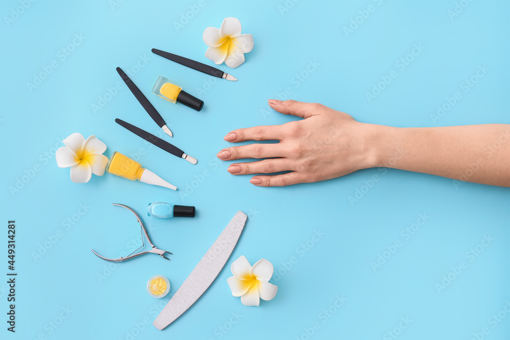 Female hand and professional tools for manicure on color background Female hand and professional tools for manicure on color background