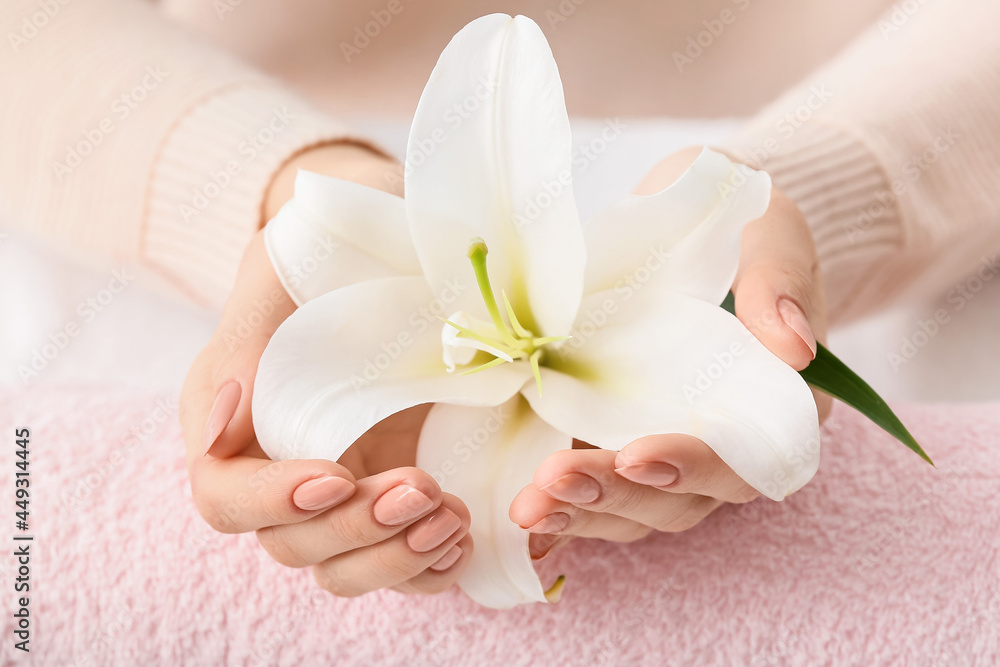 Woman with beautiful manicure and flower, closeup