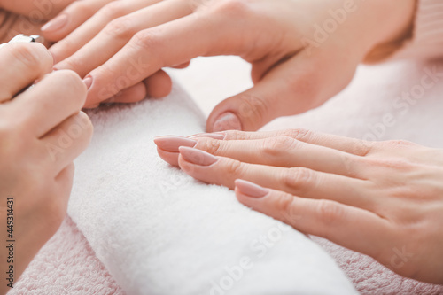 Manicure master working with female client, closeup