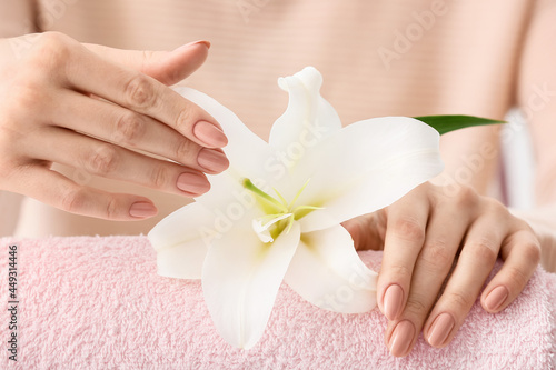 Woman with beautiful manicure and flower  closeup