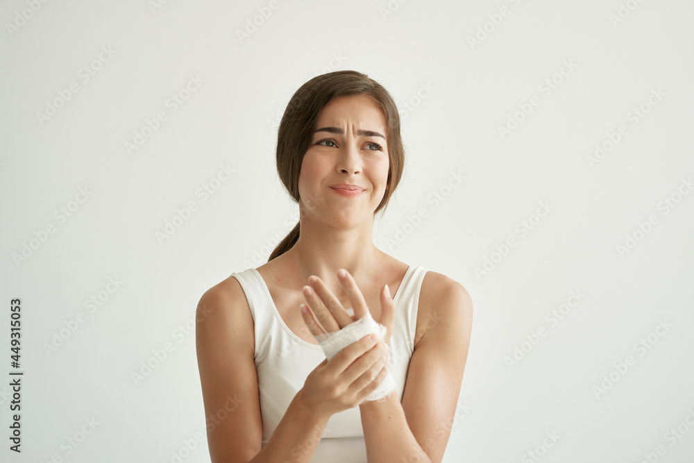 pretty brunette in white t-shirt injured arm injury discontent pretty brunette in white t-shirt injured arm injury discontent