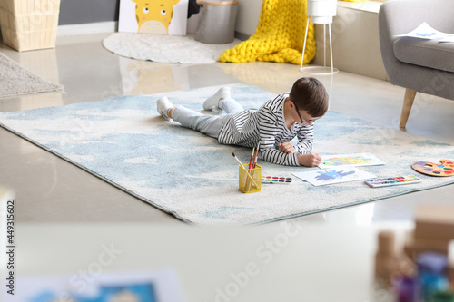 Cute little boy painting at...