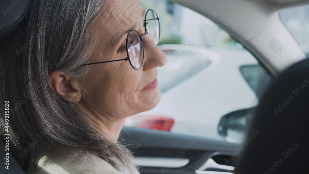 Mature tired woman sitting in car at parking lot, don’t want to go to work Mature tired woman sitting in car at parking lot, don’t want to go to work