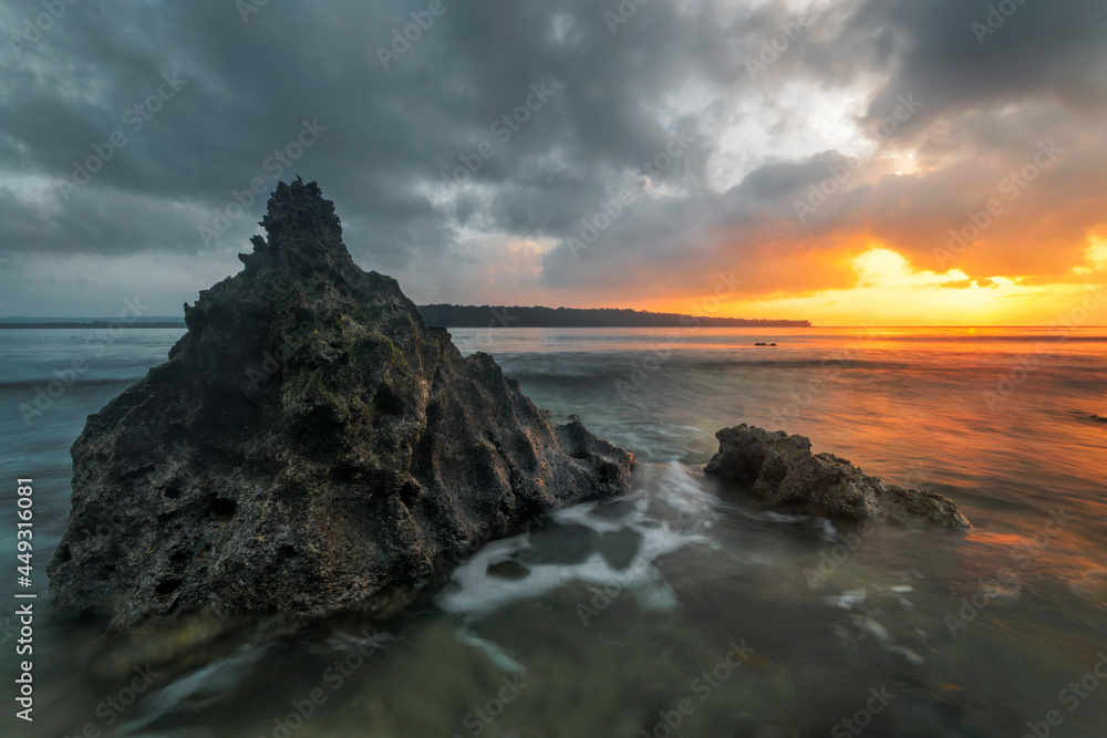 rock in the water at sunrise on vanuatu