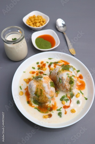 Dahi Bhalla or Dahi Vada is a type of chaat dish from India. It is prepared by soaking urad dal vadas in creamy yogurt with green and red chutney. Tri color dish. Indian Tiranga Flag colors food. photo