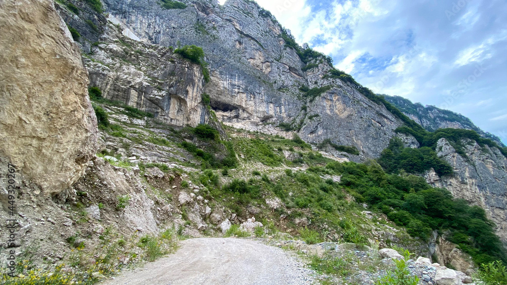 Impenetrable rocks, majestic mountains and forests. View of the road in the Gizeldon Gorge, North Ossetia, Russia.