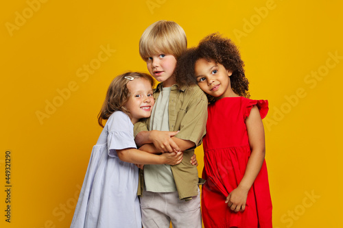 three children from different ethnic groups are friends together