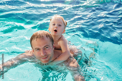 Young father with little daughter swimming in pool © dach83