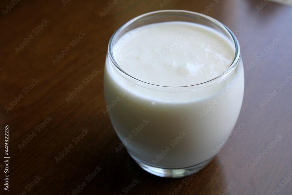 Glass of Kefir drink on wooden table, healthy drink Glass of Kefir drink on wooden table, healthy drink